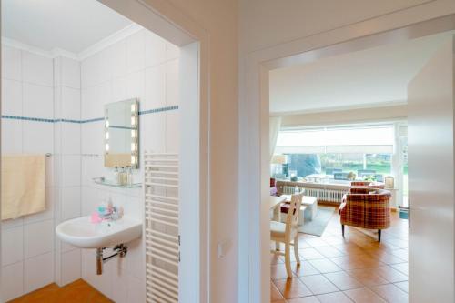文尼斯塔特Haushälfte Stranddiestel的白色的浴室设有水槽和桌子