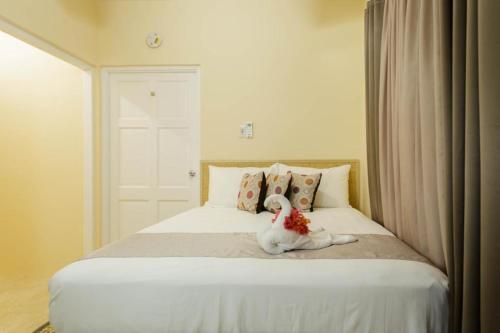 The RockCozi Cottage, A Tranquil Beauty的坐在床上的白色填充动物