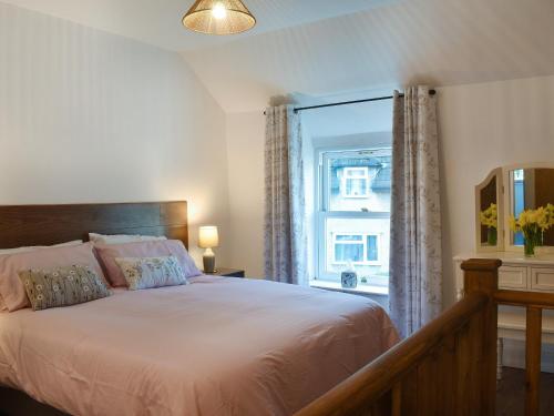 兰韦尔弗亨Nant Y Felin的一间卧室设有一张大床和一个窗户。