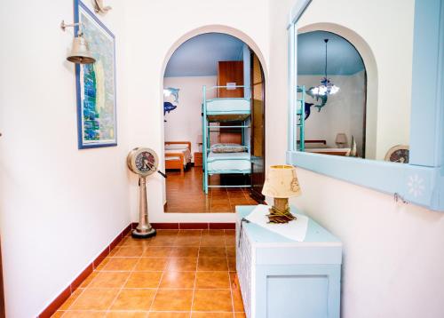 多穆斯德马里亚AFFITTACAMERE SA BRATZA VACANZE的走廊上设有一张床和镜子的房间