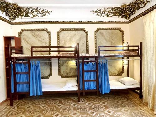 敖德萨DAY & NIGHT的配有蓝色窗帘的客房内的两张双层床