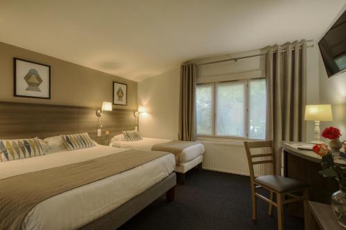 圣西尔-莱科勒圣西尔凡尔赛阿罗特尔酒店 - 寂静的舞台的酒店客房配有两张床和一张书桌