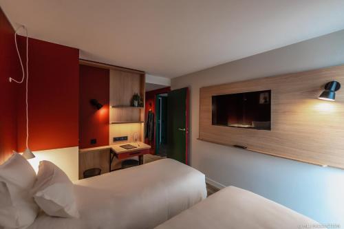 潘波勒Les Hauts de Kerano的酒店客房配有两张床和一张书桌