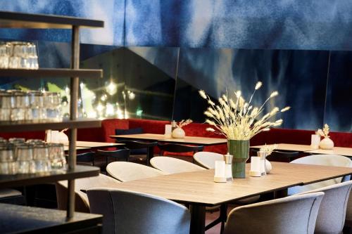 汉堡汉堡安普里奥斯堪酒店的一间带桌椅和蓝色墙壁的餐厅