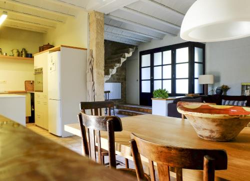 Montblanquet卡奥利维尔乡村民宿的厨房以及带桌椅的用餐室。