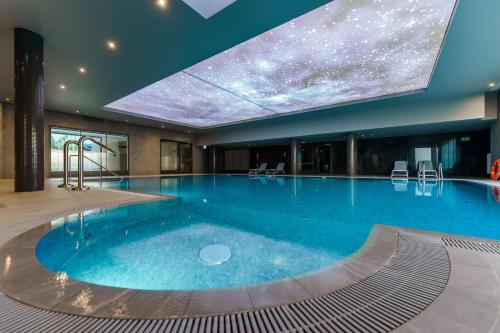 科沃布热格FACTORY RESORT wellness & spa的一座大型游泳池,位于酒店,拥有星空天花板