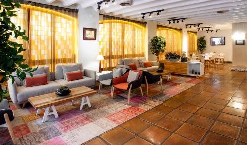 穆尔西亚加泰罗尼亚佛罗里达布兰卡伯爵酒店的大堂配有沙发、椅子和桌子