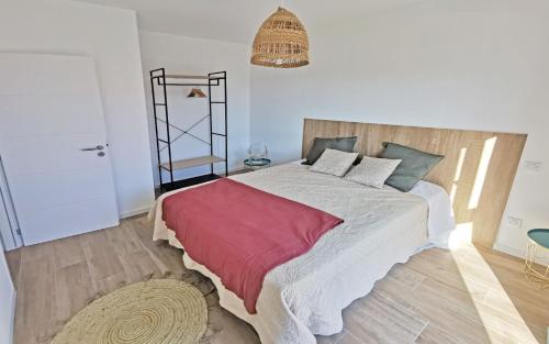 FolelliRésidence Petra Paolina的一间卧室配有一张带红色毯子的大床