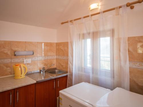 卡梅纳里阳光山度假屋的一个带水槽和窗户的小厨房