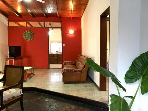 蒂格雷Casa de Tigres的带沙发和红色墙壁的客厅