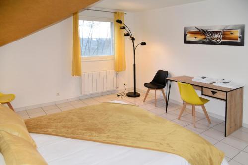 AmageVilla pré d'Oro - 1000 étangs的一间卧室配有书桌、一张床和一张桌子及椅子