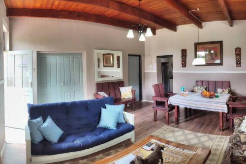 蒙塔古Tafelkop Keisie Self Catering Cottage的客厅配有蓝色的沙发和桌子