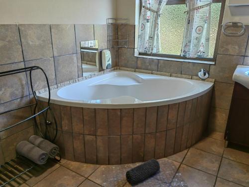 内尔斯普雷特Mountain Valley Stay - UNIT 4的带窗户的浴室设有大浴缸