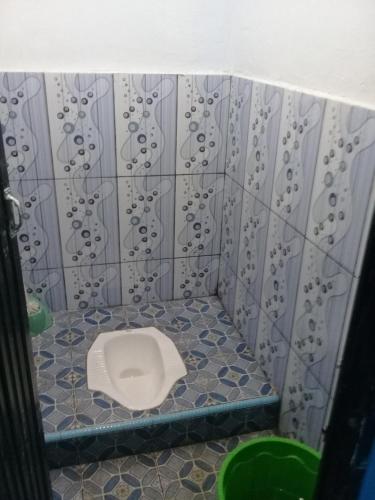 MalinoPenginapan PUTRI KEMBAR的蓝色瓷砖客房的浴室设有卫生间