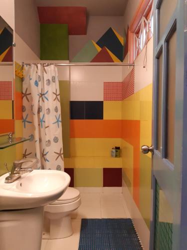 河内同吉民宿的色彩缤纷的浴室设有卫生间和水槽。