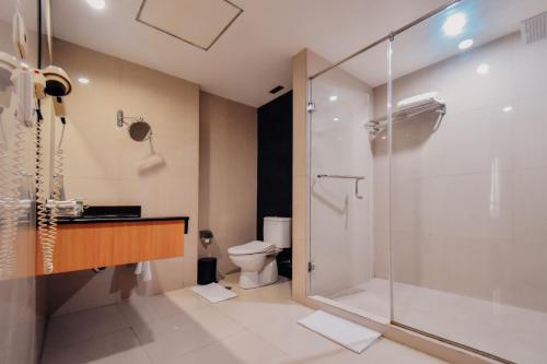 泗水Surabaya Suites Hotel Powered by Archipelago的带淋浴和卫生间的浴室
