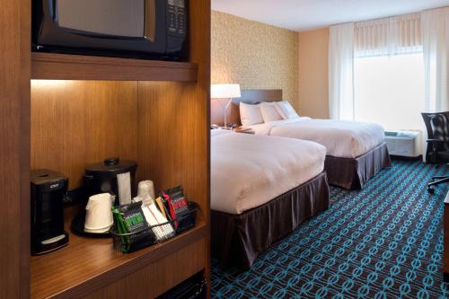 奥兰多奥兰多东/中佛罗里达大学体育馆万豪费尔菲尔德套房酒店的酒店客房设有两张床和电视。