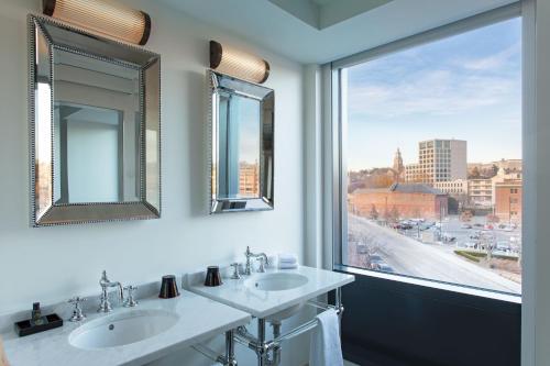 普罗维登斯Aloft Providence Downtown的一间带两个盥洗盆的浴室和一个大窗户
