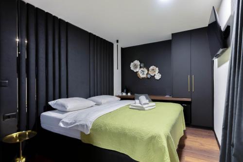 扎达尔City Premium Rooms Old town的一间卧室设有一张大床和黑色的墙壁