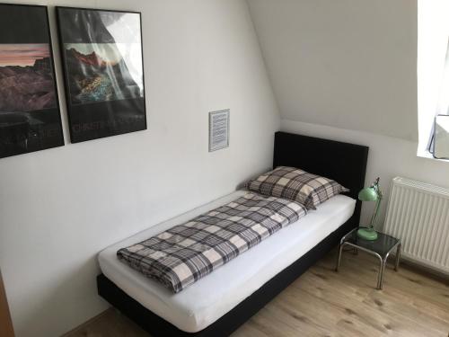 奈弗达尔Op Nijverdal的一间小卧室,配有一张带铺着地毯的床