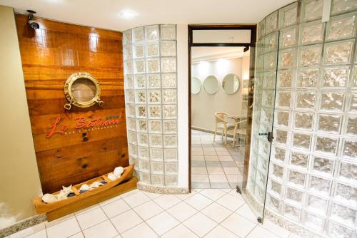 巴拉那瓜Porty Brasil Hotel的浴室内有玻璃墙的隔板的房间