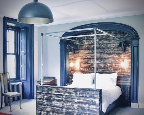 基林Suie Hunting Lodge的一间卧室配有一张带砖墙的天蓬床