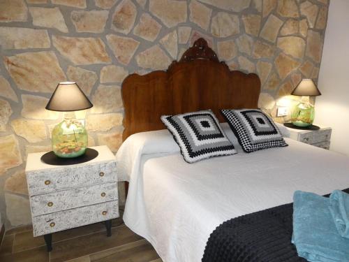 Cañada del HoyoCasa Carrasquillas的一间卧室设有一张床和石墙