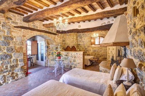 圣吉米纳诺安缇卡迪莫拉酒店的一间卧室设有两张床和石墙