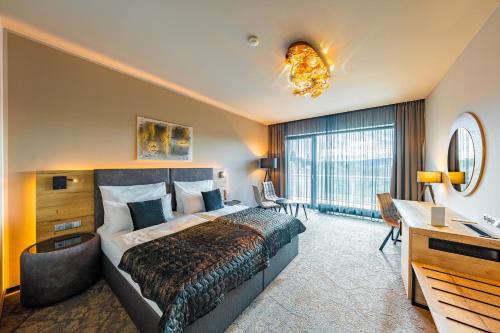 布尔诺玛克西姆斯度假酒店的配有一张床和一张书桌的酒店客房