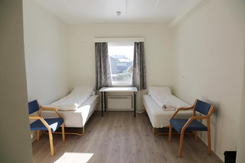 StabekkHostel Oslofjord的客房设有两张床、两把椅子和窗户。