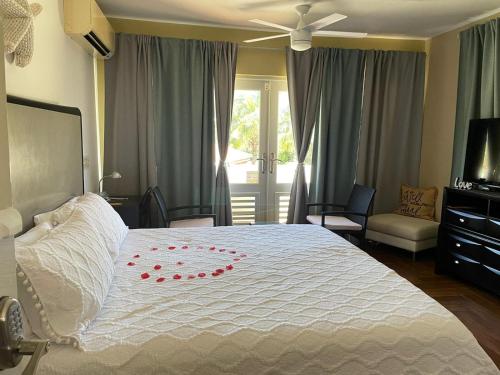 阿瓜迪亚Bella Noni B&B的卧室配有白色床,上面有红色玫瑰花瓣