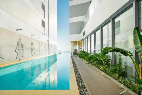 芽庄Homie Panorama Beachfront Residences Nha Trang的享有带游泳池的大楼的外部景致