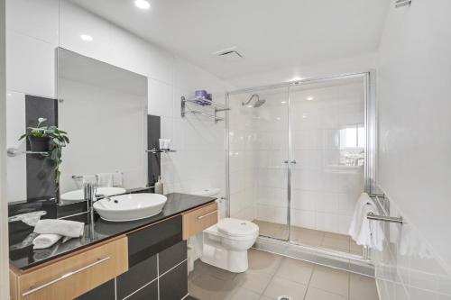 卡伦德拉Pelican Waters Golf Resort的带淋浴、卫生间和盥洗盆的浴室