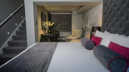 泰恩河畔纽卡斯尔利基格雷街酒店的一间带大床和楼梯的卧室