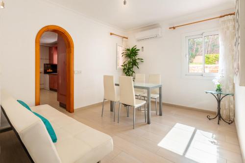 波蒂纳茨Villa Cas Puig - Beach of Portinatx的白色的客厅配有桌椅