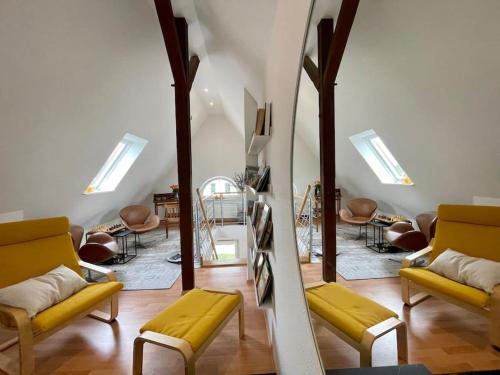 吕贝克Modernes, familienfreundliches Apartment in Lübeck的客厅配有黄色椅子和镜子