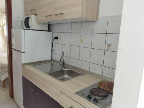 波达卡apartmani Natali的厨房配有水槽和冰箱