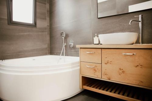 HaZore‘imCozy Beautiful Guest House的浴室配有白色浴缸和水槽
