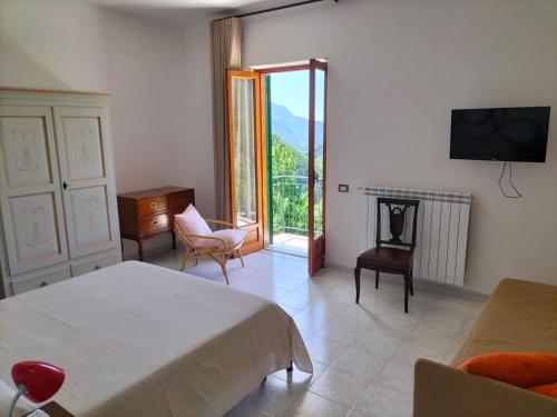 特拉蒙蒂La Casa in Vigna的一间卧室配有一张床、一个壁炉和一台电视。