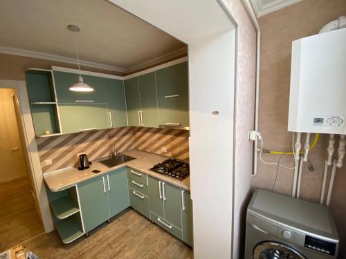 第比利斯APARTMENT in TBILISI Koko的厨房配有绿色橱柜和水槽