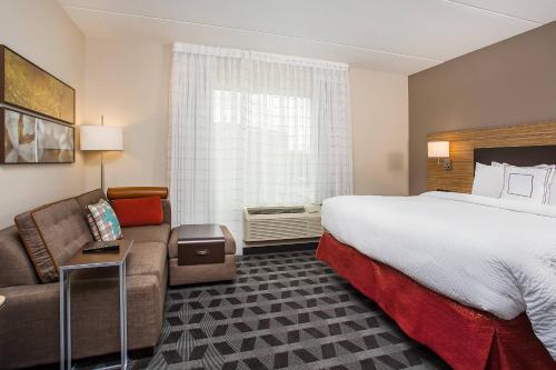 库克维尔库克维尔万豪广场套房酒店的酒店客房设有一张大床和一张沙发。