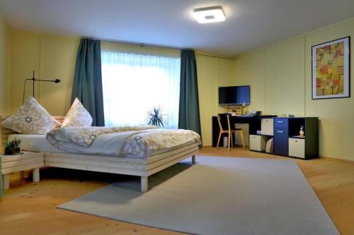 BnB Elsenerhaus的一间卧室配有一张床、一张书桌和一个窗户。