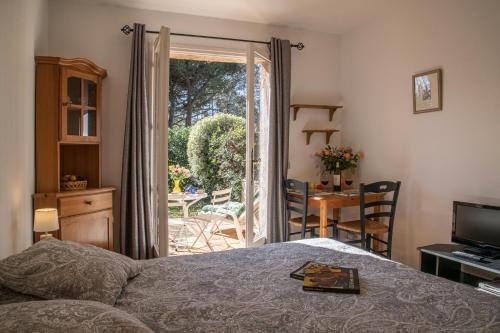圣保罗-德旺斯Le Mas des Gardettes的一间卧室设有一张床,并有通往庭院的门