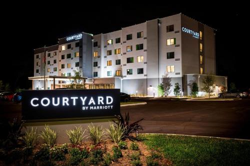 坦帕Courtyard by Marriott Tampa Northwest/Veterans Expressway的大楼前的庭院酒店标志