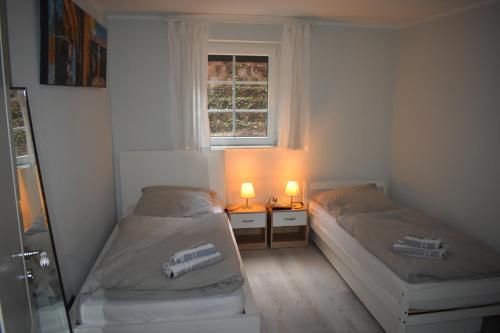 施托尔贝格Ferienwohnung JaRa 1的配有2张床的带窗户和2盏灯的客房