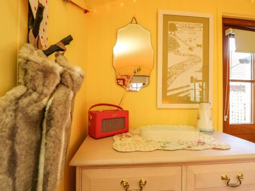 文特诺Little Worsley and The Shepherds Hut的黄色的房间,配有桌子和电视机