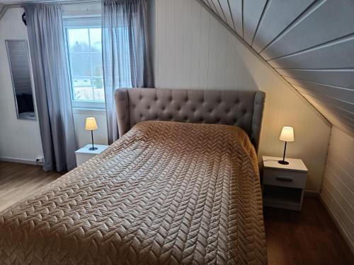 厄什塔Reinebu的一间卧室设有一张大床和大窗户