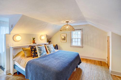 索格蒂斯Saugerties Home 3 Decks and Hudson River View的一间卧室配有一张带蓝色棉被的床和窗户。