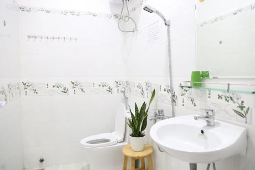大叻Strawberry Hotel Dalat的白色的浴室设有水槽和卫生间。