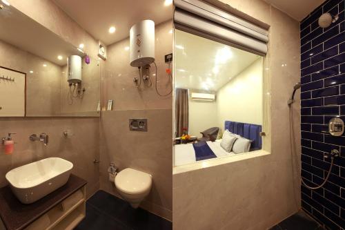 法里达巴德Hotel Bay Laurel Retreat的一间带水槽、卫生间和镜子的浴室